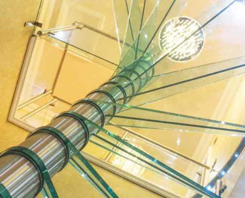 looking up at the glass steps of a spiral staircase