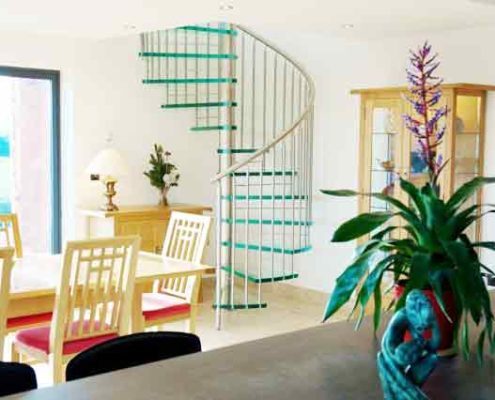 modern living space with table and glass spiral stair
