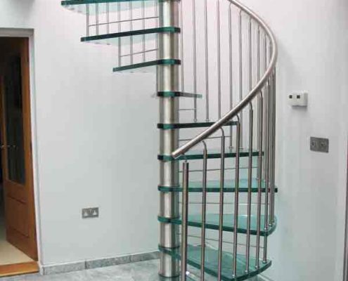 glass spiral stair with uplights