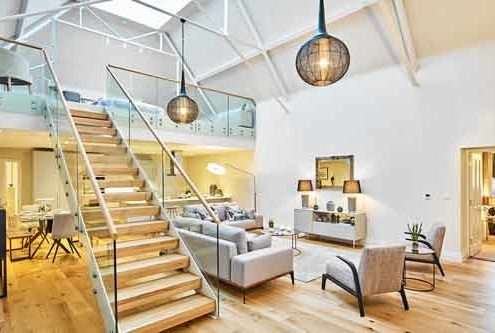 straight flight white , wood and steel stair rising to a mezzanine