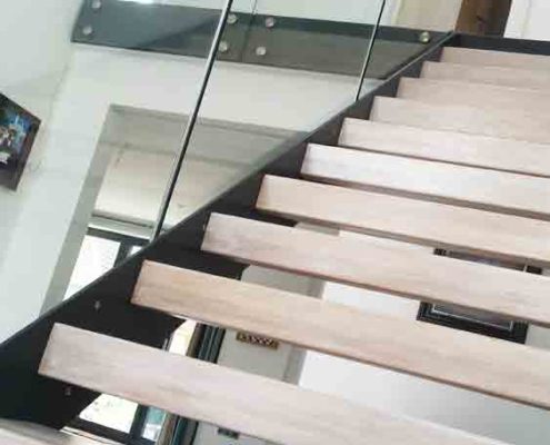 close up of open riser staircase with light wooden steps