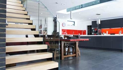 dining and kitchen area with modern open staircase