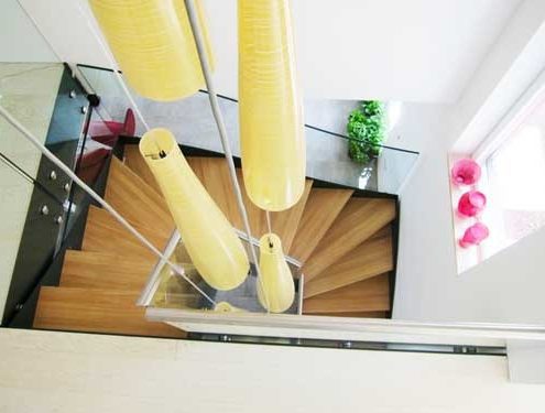 looking down on a half turn oak and glass staircase