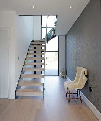 light wooden floor with modern stair rising Infront of window
