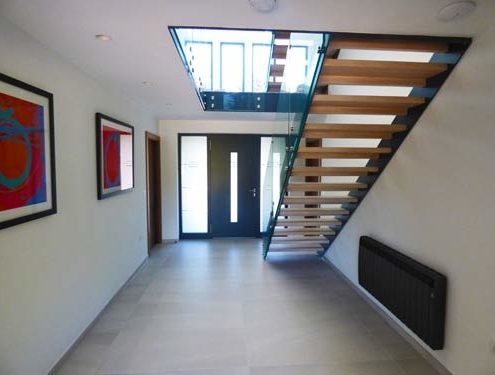 hallway with tiled floor and open riser staircase