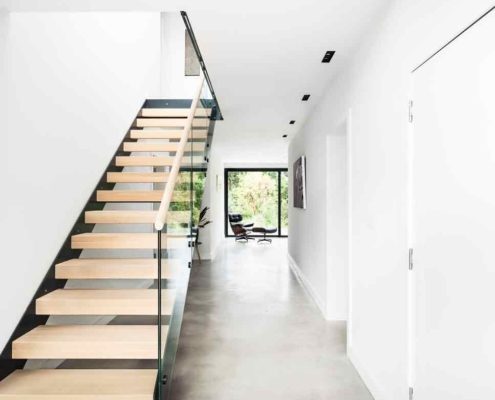 clean and light hallway with modern steel and glass staircase