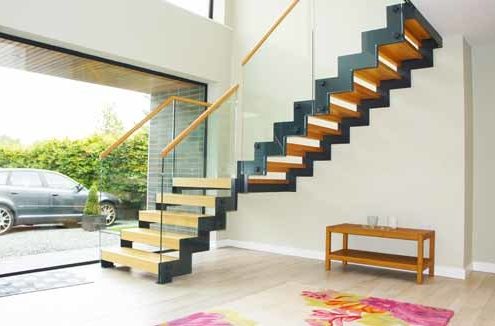 large window in hallway with moderns staircase with zig zag stringers