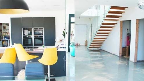 polished concreate floor in a house with kitchen and modern open stair