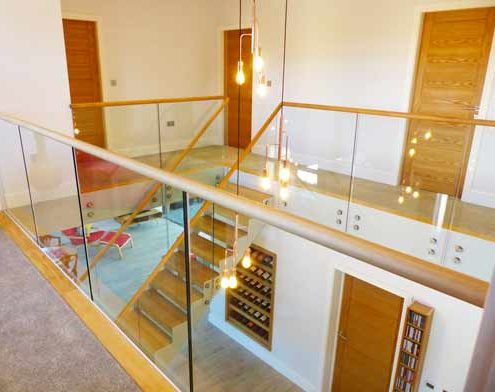 glass landing balustrade around large stair void