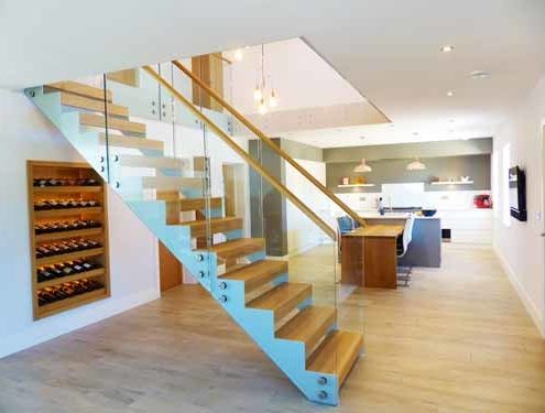 White steel staircase in modern house with glass panels