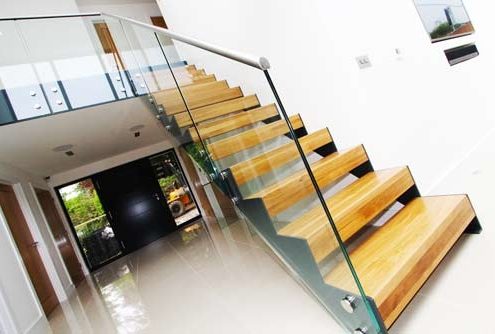 glass sides to a modern open riser stair in a hallway