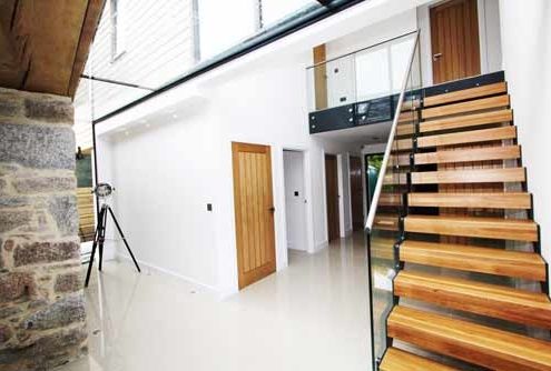 light hallway with tiled floor and open riser stair
