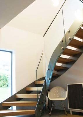 modern open riser stair with wooden steps and glass panels