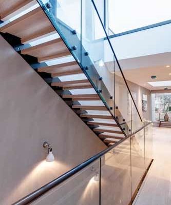 glass balustrade over stairwell with straight flight modern stair above