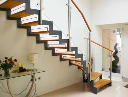 dark grey steel stringers on a timber step and open riser stair