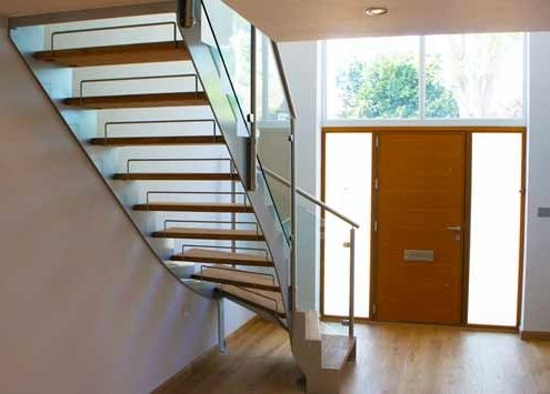 hallway with window and steel and glass staircase