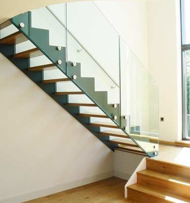 modern open riser stair with timber floor below