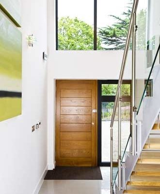 light and open hallway with steel stringers and glass balustrade