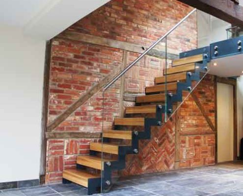 old brick wall behind a modern stair