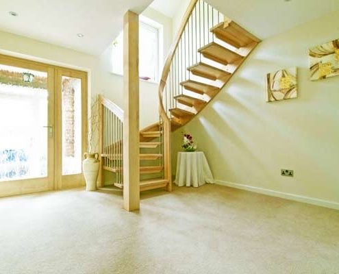 hallway with floating half turn wooden staircase