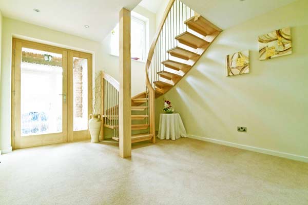 hallway with floating half turn wooden staircase