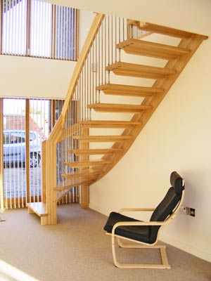 hallway with black chair and a quarter turn staircase