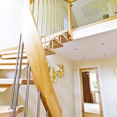 curved handrail on a light and open wooden stair