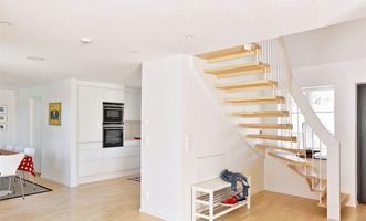 white handrail and spindles on a light open floating stair with timber floor