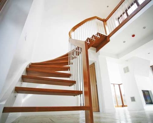 looking up at a curving quarter staircase in a floating style