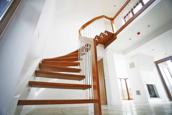 looking up at a curving quarter staircase in a floating style
