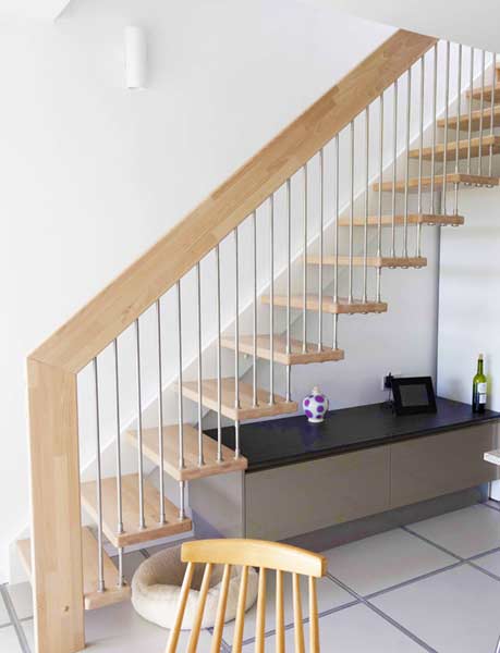 straight flight light wood open staircase with white wall stringer