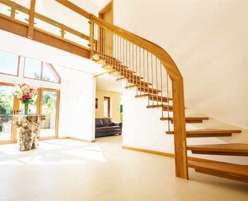 open riser staircase against a white wall in a modern hallway