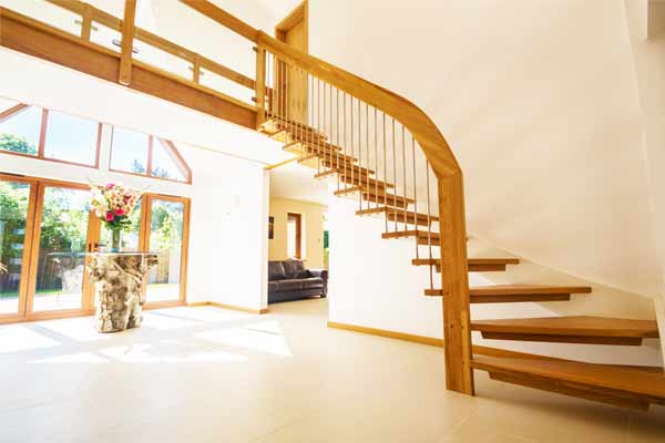 open riser staircase against a white wall in a modern hallway