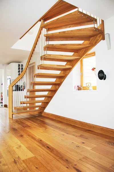 oak floor with a floating oak staircase above