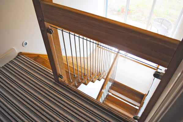 glass landing balustrade above a half turn oak stair