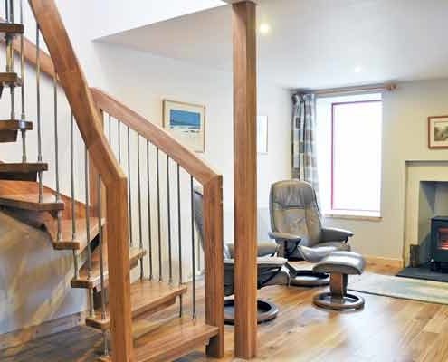 floating oak staircase in a living room