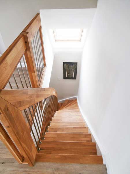 looking down a wooden staircase with landing balustrade