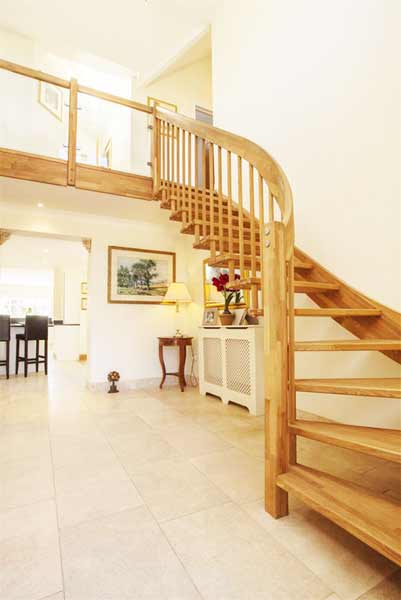 tiled floor and oak staircase ascending