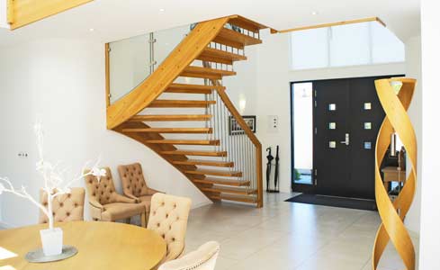 large hallway with turning open staircase leading up