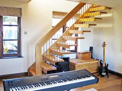 floating staircase in music room with keyboard