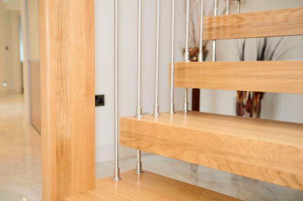 close up of a wooden step on a floating staircase