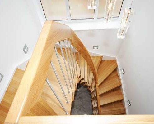 an oak curved handrail on a half turn oak stair