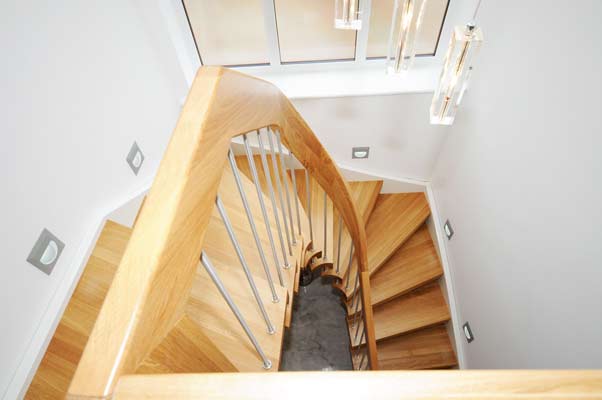 an oak curved handrail on a half turn oak stair