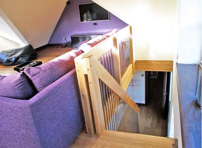 looking down a stairwell with a purple sofa to one side