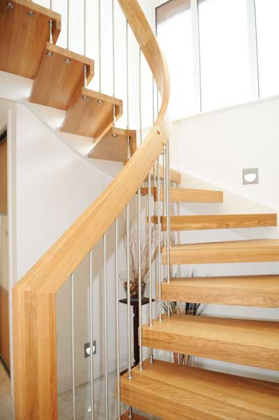 curved inner handrail of a floating wood staircase