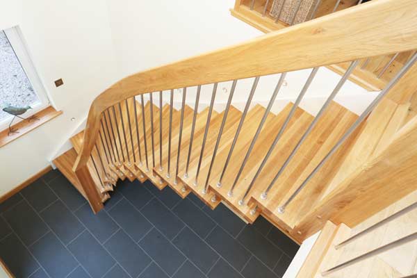 side view of an oak floating style stair with grey floor below