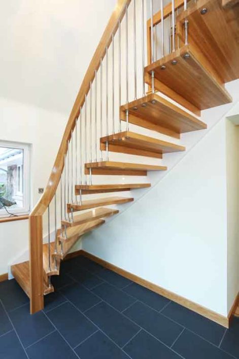 oak step open floating staircase and dark grey tiled floor