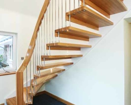 oak step open floating staircase and dark grey tiled floor