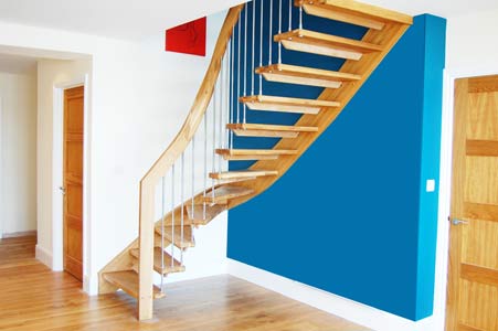 turning oak staircase with open risers and blue wall