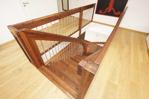 walnint staircase from above with landing balustrade around opening
